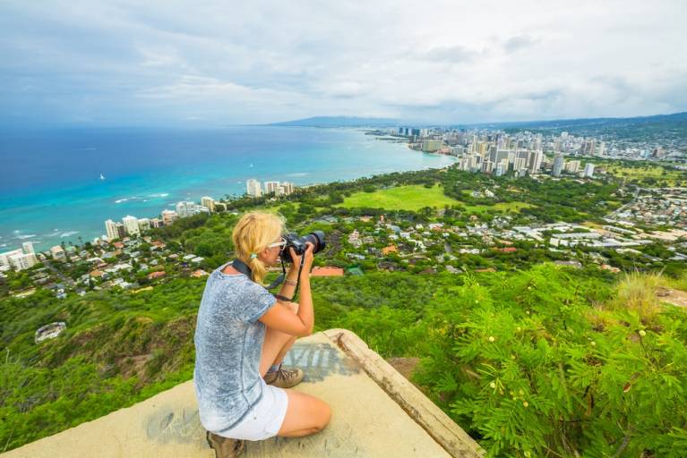 person taking photo in Oahu from top of Diamond Head